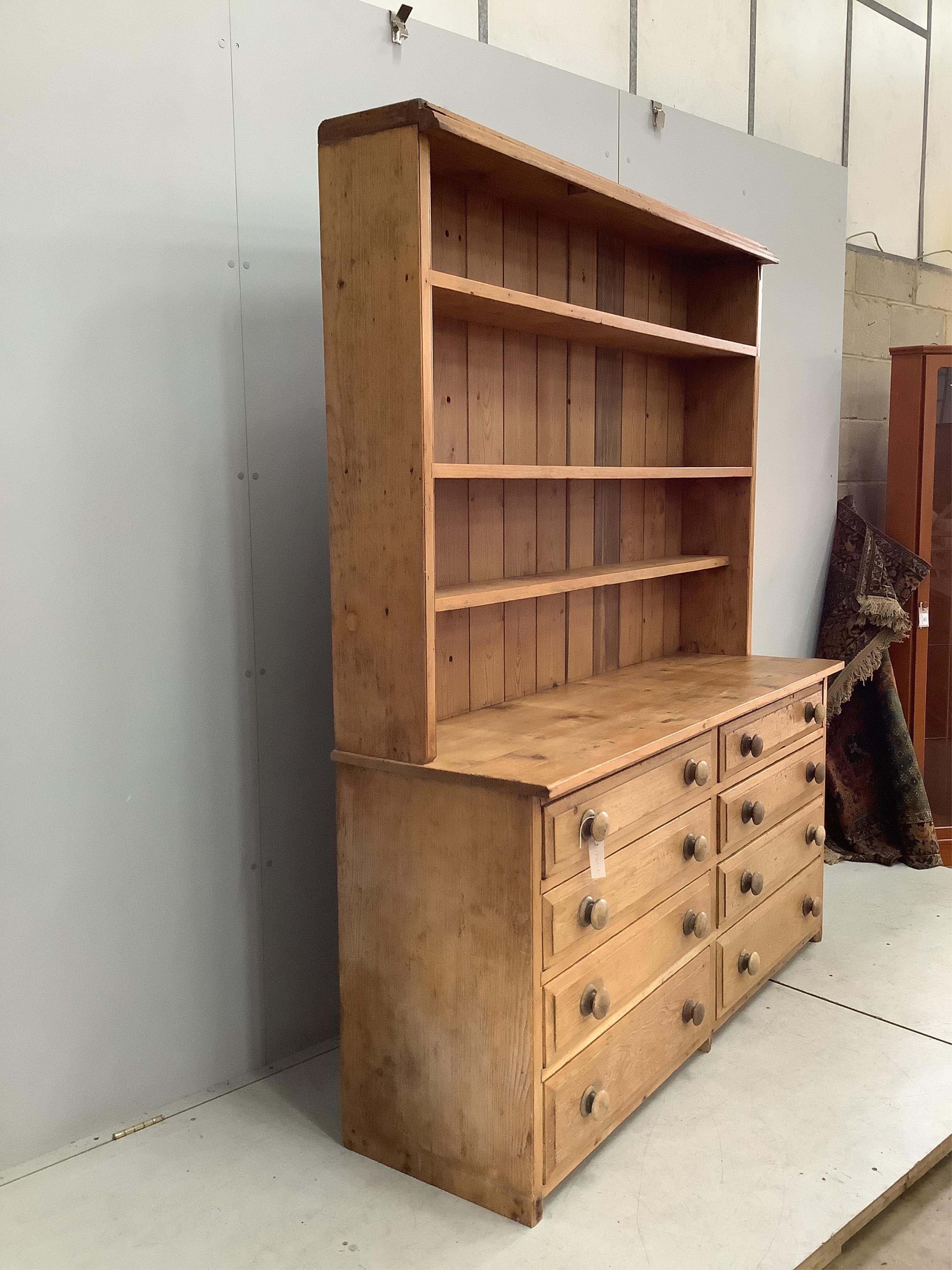 A Victorian style pine eight drawer dresser with boarded rack, width 157cm, depth 50cm, height 197cm. Condition - fair